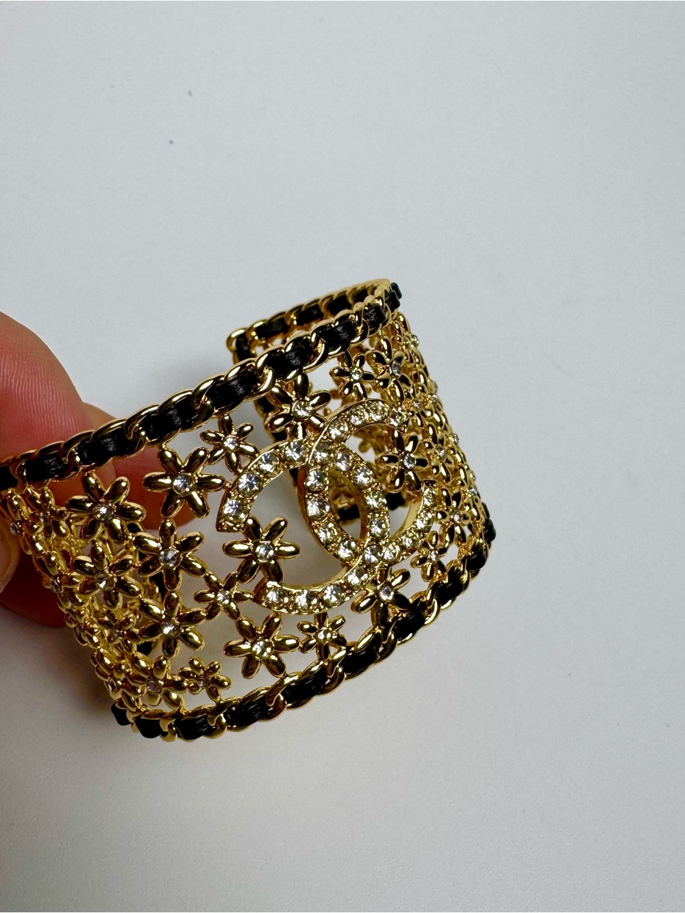 Chanel Métiers d'Art flower motif gold cuff bracelet rhinestones black weaving